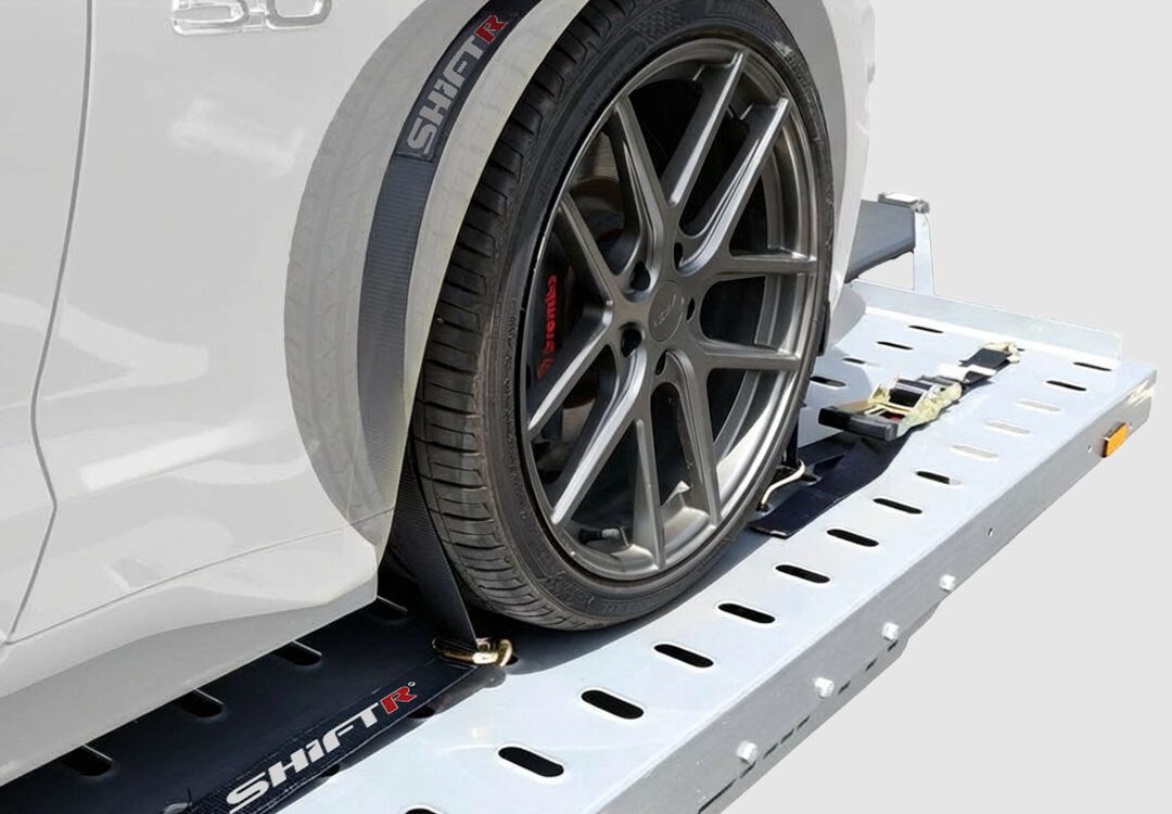 Why Over-Tire Tie-Downs Are the Proper Way to Secure a Car on a Car Hauler